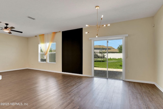 2351 Oak Stream Dr, Green Cove Springs, FL 32043 - empty room with visible vents, baseboards, wood finished floors, and ceiling fan with notable chandelier
