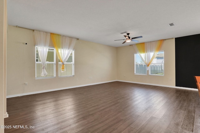 2351 Oak Stream Dr, Green Cove Springs, FL 32043 - unfurnished room featuring baseboards, dark wood-style flooring, ceiling fan, and visible vents