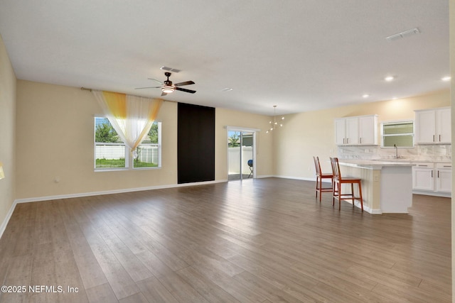 2351 Oak Stream Dr, Green Cove Springs, FL 32043 - unfurnished living room featuring visible vents, a ceiling fan, and wood finished floors