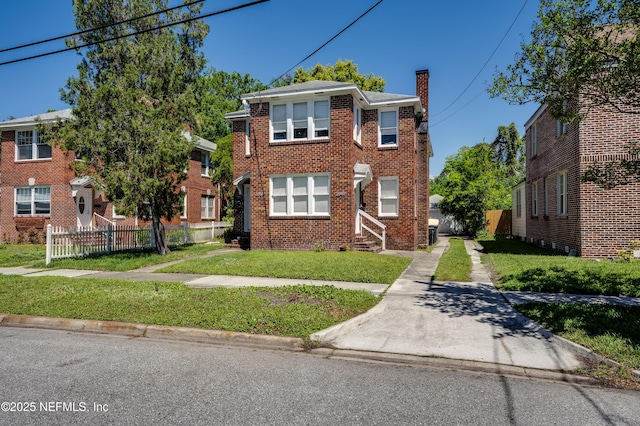 2649 Dellwood Ave, Jacksonville, FL 32204 - view of front facade with brick siding, a chimney, fence, and a front lawn
