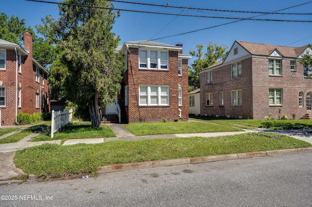 2649 Dellwood Ave, Jacksonville, FL 32204 - view of front of home with a front yard, fence, and brick siding