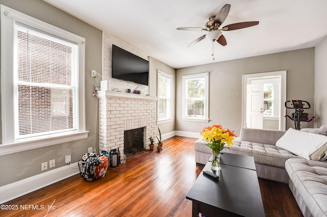 2649 Dellwood Ave, Jacksonville, FL 32204 - living room featuring wood finished floors, ceiling fan, baseboards, and a brick fireplace
