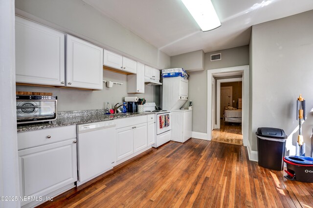 2649 Dellwood Ave, Jacksonville, FL 32204 - kitchen with dark wood finished floors, white appliances, white cabinetry, visible vents, and stacked washer / drying machine