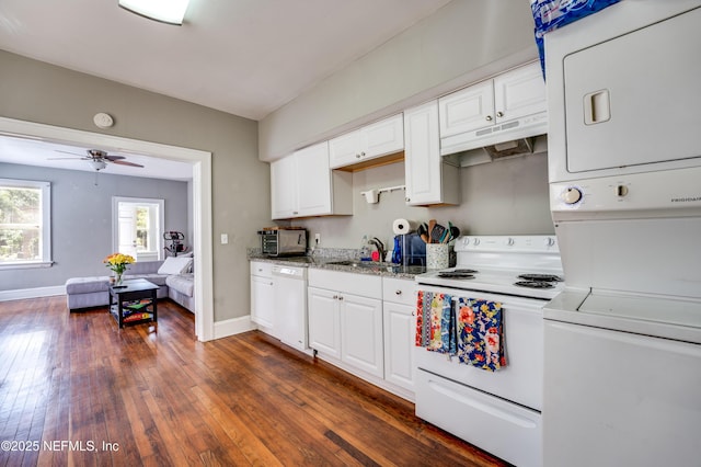 2649 Dellwood Ave, Jacksonville, FL 32204 - kitchen with white appliances, stacked washing maching and dryer, dark wood-type flooring, under cabinet range hood, and a sink
