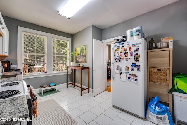 2649 Dellwood Ave, Jacksonville, FL 32204 - kitchen featuring light countertops, freestanding refrigerator, baseboards, and light tile patterned floors
