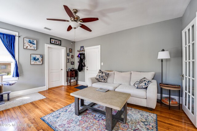 2649 Dellwood Ave, Jacksonville, FL 32204 - living room with visible vents, baseboards, a ceiling fan, and wood finished floors