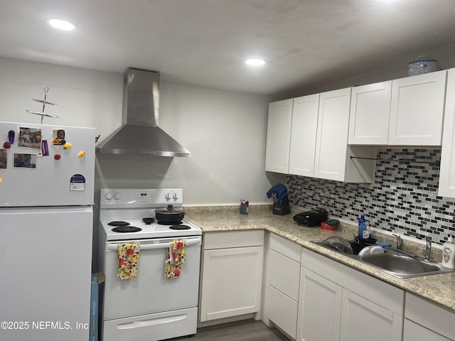 2552 Spirea St, Jacksonville, FL 32209 - kitchen with wall chimney exhaust hood, white cabinets, a sink, white appliances, and light countertops