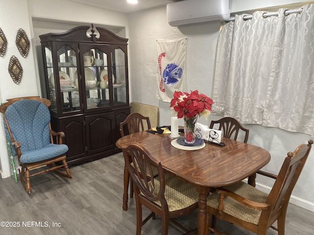 2552 Spirea St, Jacksonville, FL 32209 - dining area with a textured wall, wood finished floors, and a wall mounted AC