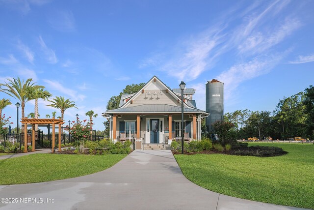 2781 Seasons Rd, Green Cove Springs, FL 32043 - view of front of property featuring fence, a pergola, a front lawn, a porch, and metal roof