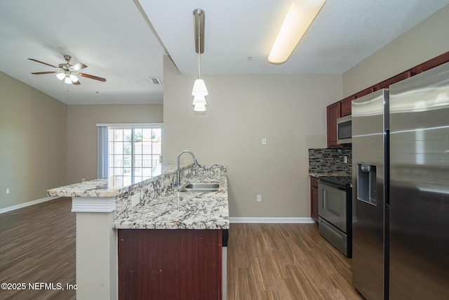 8235 Lobster Bay Ct Unit 305, Jacksonville, FL 32256 - kitchen with a sink, ceiling fan, appliances with stainless steel finishes, a peninsula, and dark wood-style floors