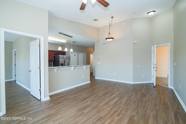 8235 Lobster Bay Ct Unit 305, Jacksonville, FL 32256 - unfurnished living room featuring wood finished floors, baseboards, a ceiling fan, and visible vents