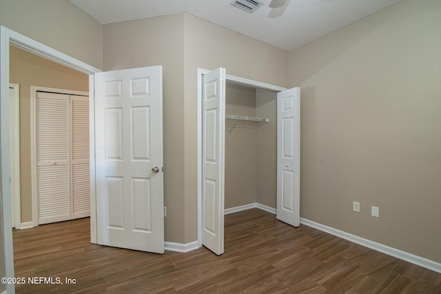 8235 Lobster Bay Ct Unit 305, Jacksonville, FL 32256 - unfurnished bedroom with visible vents, baseboards, a closet, and wood finished floors
