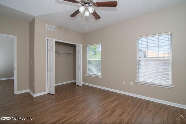 8235 Lobster Bay Ct Unit 305, Jacksonville, FL 32256 - unfurnished bedroom featuring a closet, baseboards, dark wood-style floors, visible vents, and ceiling fan