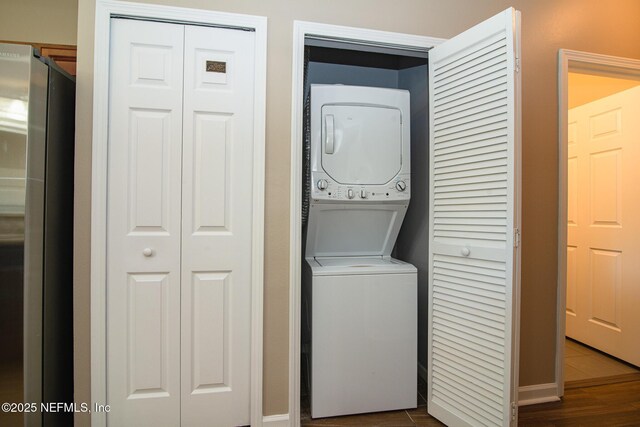8235 Lobster Bay Ct Unit 305, Jacksonville, FL 32256 - clothes washing area featuring laundry area, stacked washer / drying machine, and dark wood finished floors