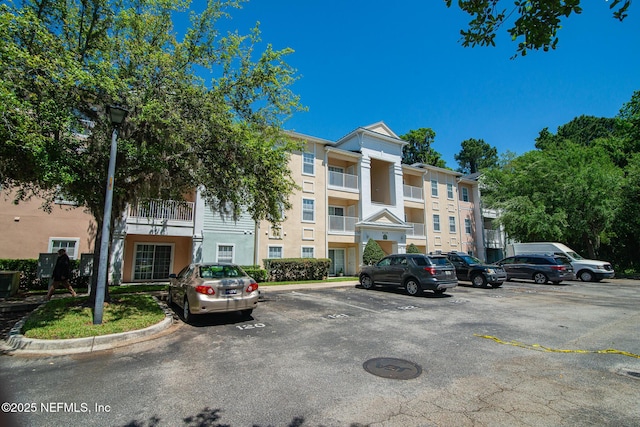 8235 Lobster Bay Ct Unit 305, Jacksonville, FL 32256 - view of building exterior featuring uncovered parking
