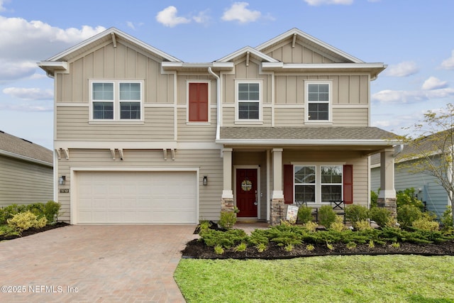 75743 Spoonbill Ln, Yulee, FL 32097 - craftsman house featuring board and batten siding, decorative driveway, and an attached garage