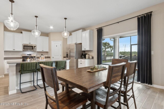 75743 Spoonbill Ln, Yulee, FL 32097 - dining space featuring baseboards, wood tiled floor, and recessed lighting