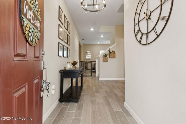 75743 Spoonbill Ln, Yulee, FL 32097 - foyer featuring visible vents, baseboards, an inviting chandelier, and light wood-style flooring
