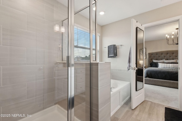 75743 Spoonbill Ln, Yulee, FL 32097 - ensuite bathroom with a stall shower, a garden tub, wood finished floors, and ensuite bath