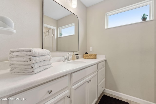 75743 Spoonbill Ln, Yulee, FL 32097 - bathroom featuring vanity, baseboards, and a healthy amount of sunlight
