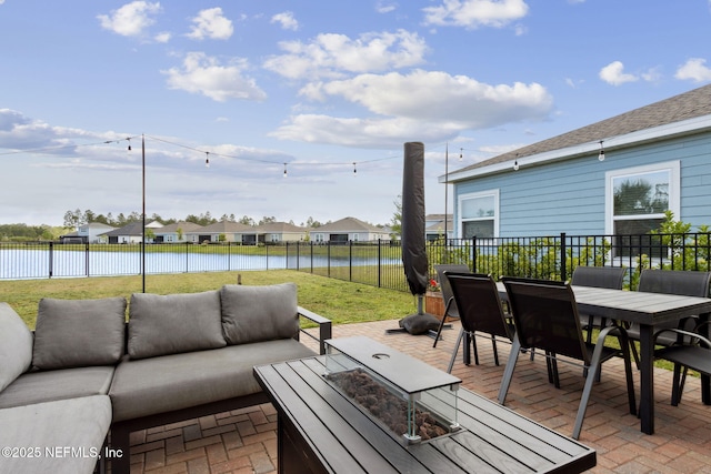 75743 Spoonbill Ln, Yulee, FL 32097 - view of patio / terrace with a water view, an outdoor living space with a fire pit, a fenced backyard, outdoor dining area, and a residential view