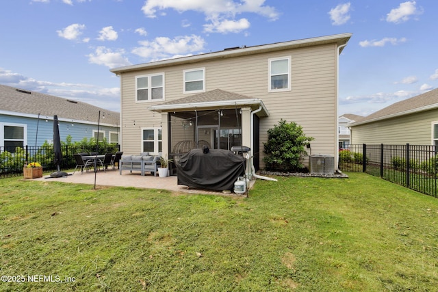 75743 Spoonbill Ln, Yulee, FL 32097 - rear view of house with central AC unit, a sunroom, a patio area, a yard, and a fenced backyard