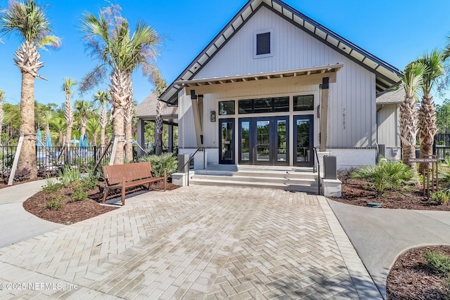 75743 Spoonbill Ln, Yulee, FL 32097 - exterior space featuring french doors, board and batten siding, and fence
