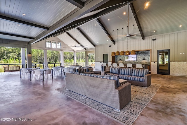 75743 Spoonbill Ln, Yulee, FL 32097 - living room featuring high vaulted ceiling, beamed ceiling, concrete flooring, and a ceiling fan