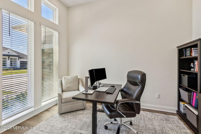 office area featuring baseboards and wood finished floors
