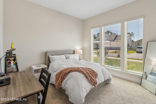 bedroom with carpet flooring and baseboards