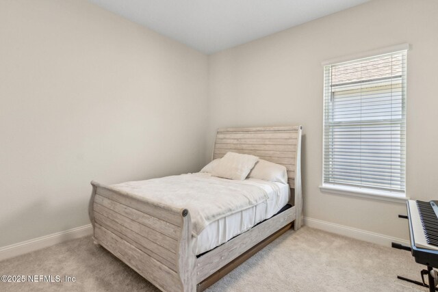 bedroom with baseboards and carpet