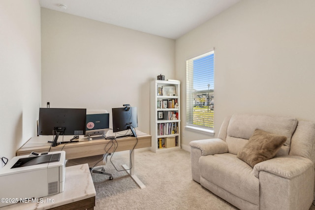 carpeted office space featuring baseboards