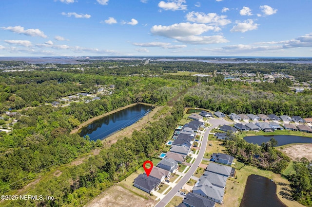 bird's eye view featuring a water view, a view of trees, and a residential view