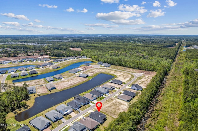bird's eye view featuring a water view, a residential view, and a wooded view