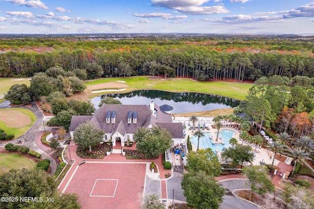 birds eye view of property with a forest view, golf course view, and a water view