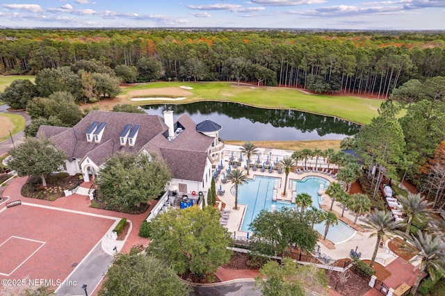 aerial view with a wooded view and a water view