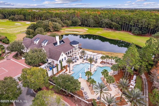 bird's eye view featuring a wooded view, golf course view, and a water view