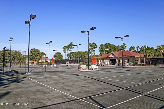 view of sport court featuring fence