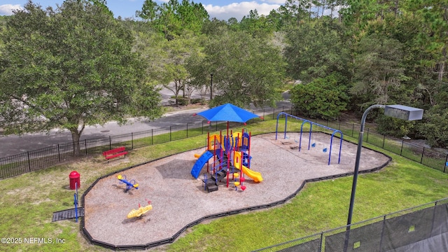 community play area featuring fence and a lawn