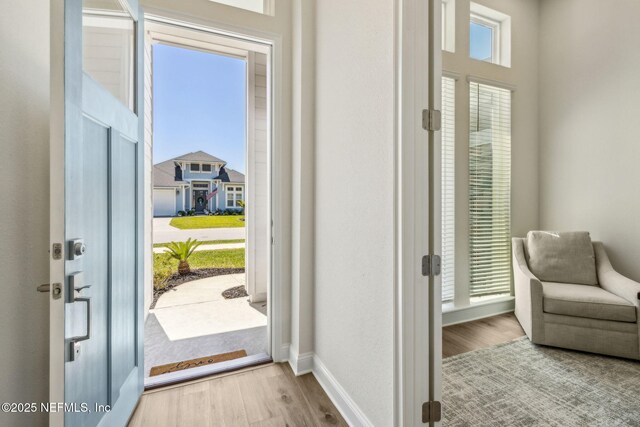 entryway featuring baseboards and wood finished floors