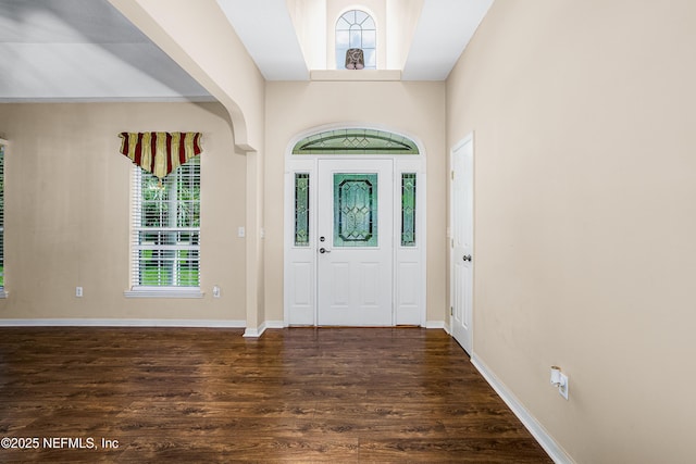 entrance foyer with dark wood-type flooring and baseboards