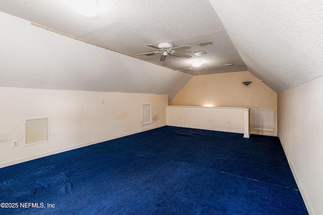 bonus room with visible vents, a textured ceiling, a ceiling fan, and lofted ceiling