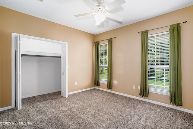 unfurnished bedroom featuring carpet floors, baseboards, a closet, and ceiling fan