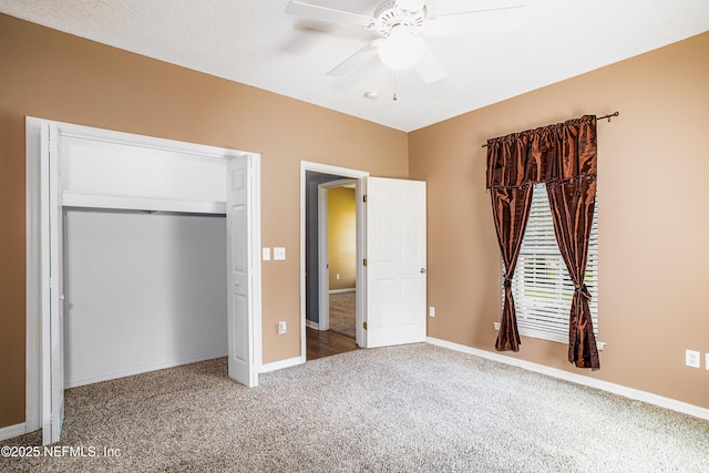 unfurnished bedroom with a closet, baseboards, a ceiling fan, and carpet