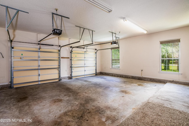 garage with baseboards and a garage door opener