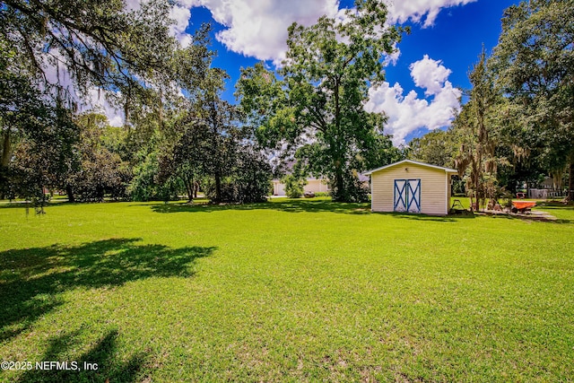 view of yard featuring a storage shed and an outbuilding