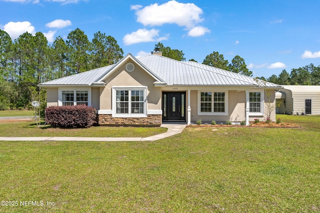 12531 County Road 121, Bryceville, FL 32009 - view of front of house with a front lawn, stone siding, metal roof, and stucco siding
