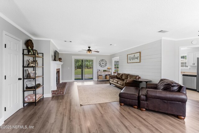 12531 County Road 121, Bryceville, FL 32009 - living room with crown molding, ceiling fan, a brick fireplace, and wood finished floors