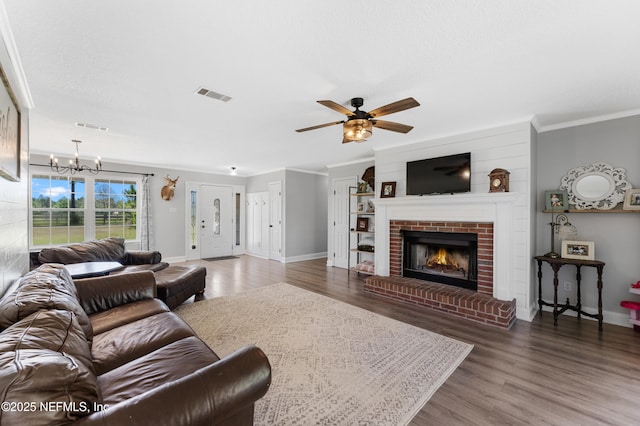 12531 County Road 121, Bryceville, FL 32009 - living area with ceiling fan with notable chandelier, a fireplace, ornamental molding, and visible vents