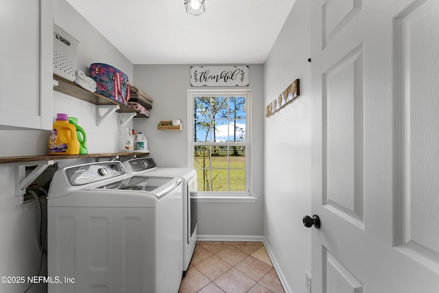 12531 County Road 121, Bryceville, FL 32009 - clothes washing area with light tile patterned flooring, baseboards, cabinet space, and washer and clothes dryer